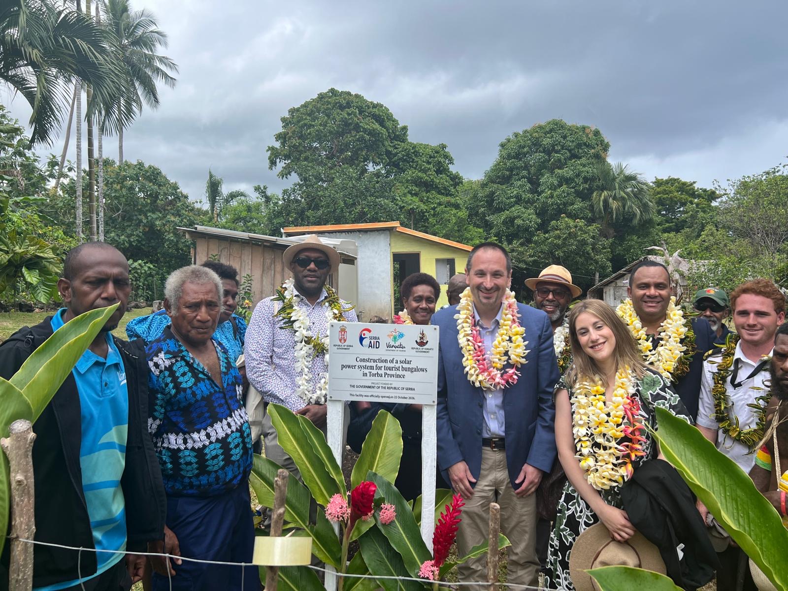 H.E. Rade Stefanović, Ambassador of the Republic of Serbia to Vanuatu (centre), with the official delegation and the Gaua community at the project plaque.